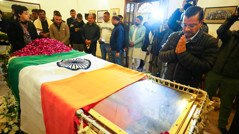 Arvind Kejriwal pays his last respects to former prime minister Manmohan Singh, in New Delhi, Friday, Dec. 27, 2024. Delhi Chief Minister Atishi is also seen.