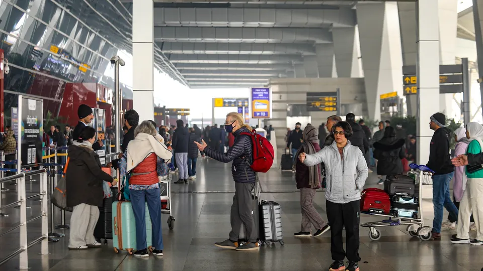 Passengers at Indira Gandhi International Airport during a cold and foggy winter morning, in New Delhi, Saturday, Jan. 4, 2025