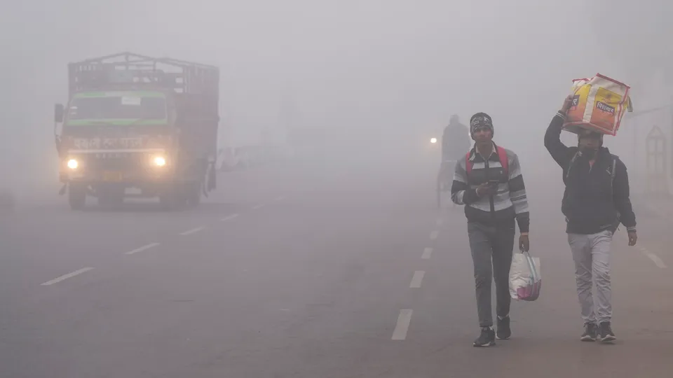 Commuters on a road amid dense fog during a cold winter morning, in Lucknow, Monday, Jan. 6, 2025.