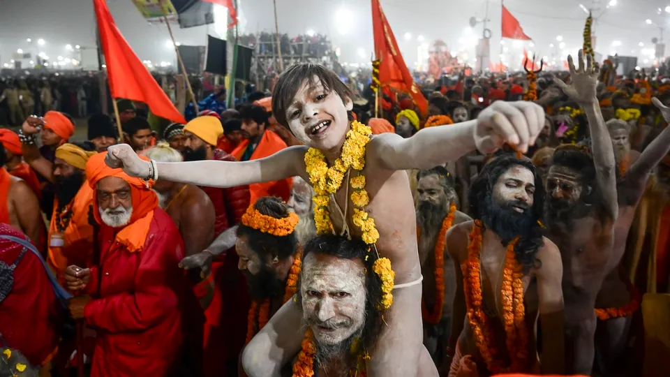 A 'Naga Sadhu' with a young devotee at Sangam on the occasion of 'Makar Sankranti' during the Maha Kumbh Mela 2025 in Prayagraj  on Tuesday, Jan. 14, 2025.