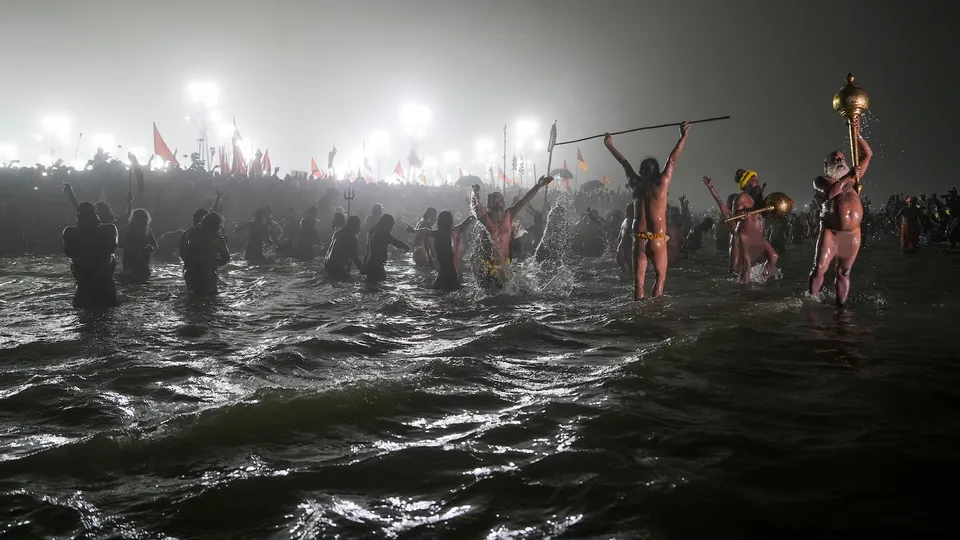 Sadhus take a holy dip at the Sangam on the 'Makar Sankranti' festival, during the Mahakumbh Mela, in Prayagraj, Tuesday, Jan. 14, 2025.