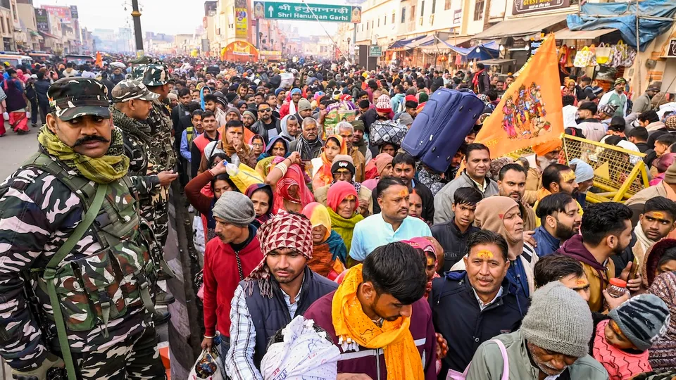 Security personnel stand guard as devotees visit the Hanuman Garhi Temple after taking a holy dip in Sarayu river in Ayodhya on Tuesday, Jan. 28, 2025.