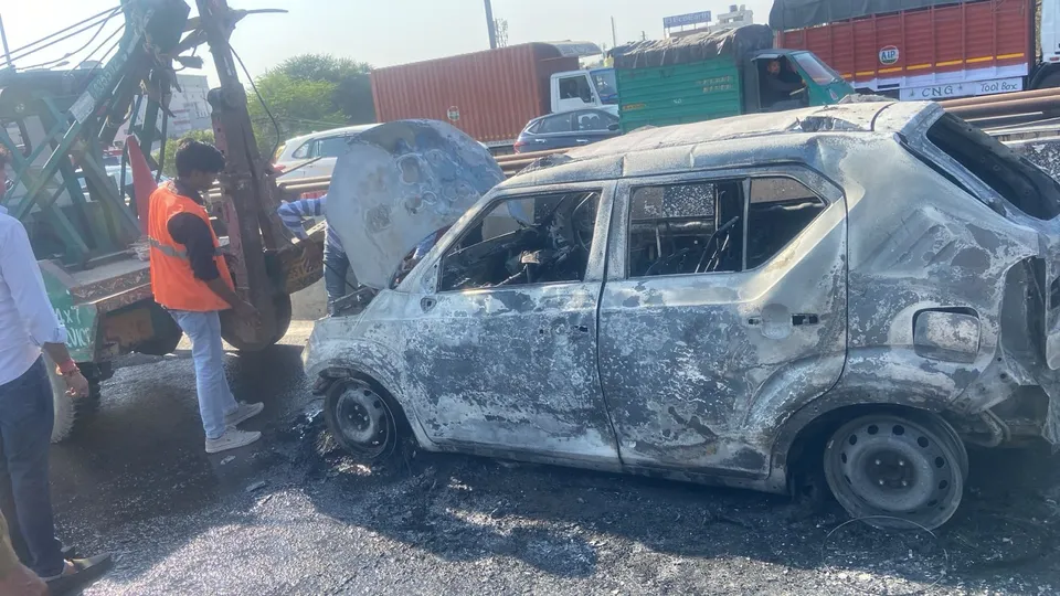 A car catches fire on Hero Honda Chowk flyover in Gurugram on Tuesday, Feb 18. 2025.
