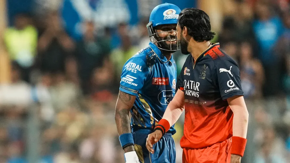 Mumbai Indians' Hardik Pandya and Royal Challengers Bengaluru's Krunal Pandya interact during an IPL match at the Wankhede Stadium in Mumbai on Monday, April 7, 2025.