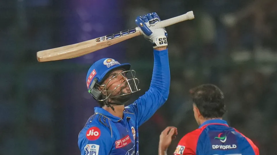 Mumbai Indians' Tilak Varma celebrates his half century against Delhi Capitals at the Arun Jaitley Stadium in New Delhi on Sunday, April 13, 2025.