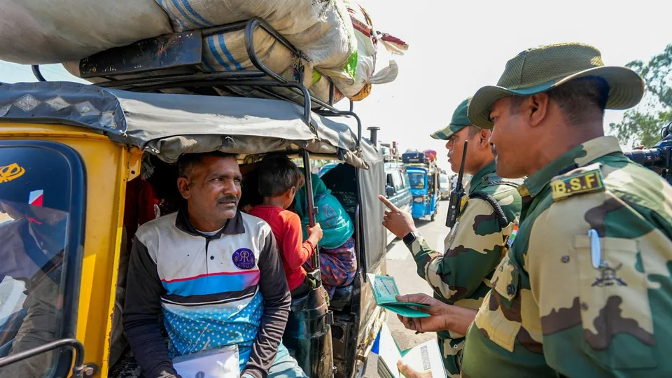 BSF personnel check documents of Pakistan citizens arrived to cross over to their country, at Attari-Wagah border near Amritsar.