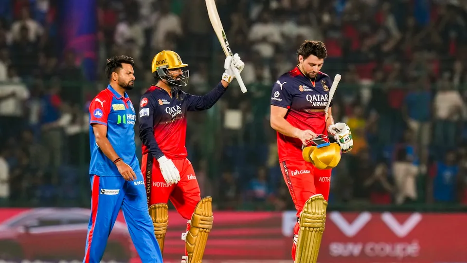 Royal Challengers Bengaluru's Krunal Pandya and Tim David celebrate after beating Delhi Capitals at the Arun Jaitley Stadium in New Delhi on Sunday, April 27, 2025.