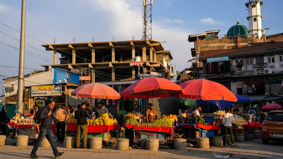 People shop at a market, seen after India and Pakistan agreed to a ceasefire in Srinagar on Saturday, May 10, 2025.