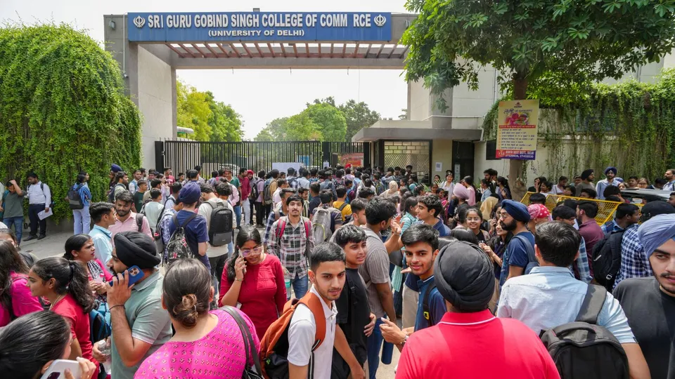 Students wait outside Guru Gobind Singh College of Commerce after a fire broke out in its library, in northwest Delhi's Pitampura.