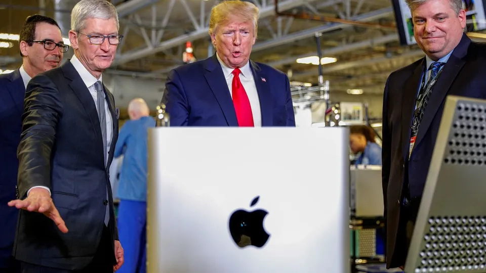 In this file photo from Nov. 20, 2019, Apple CEO Tim Cook, left center, escorts President Donald Trump as he tours Apple’s Mac Pro manufacturing plant in Austin, Texas.