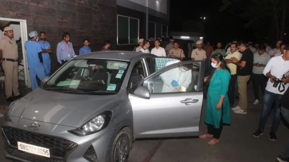 Police and forensic officials examine the car in which seven family members were found dead on Monday night in Panchkula.