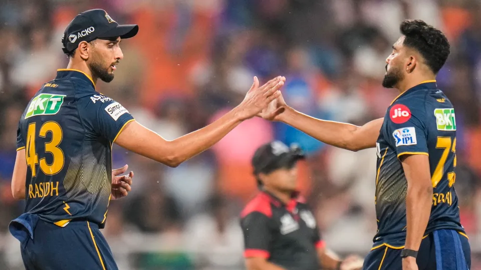 Gujarat Titans' Mohammed Siraj and Prasidh Krishna celebrate the wicket of Mumbai Indians' Tilak Varma in New Chandigarh on Friday, May 30, 2025.