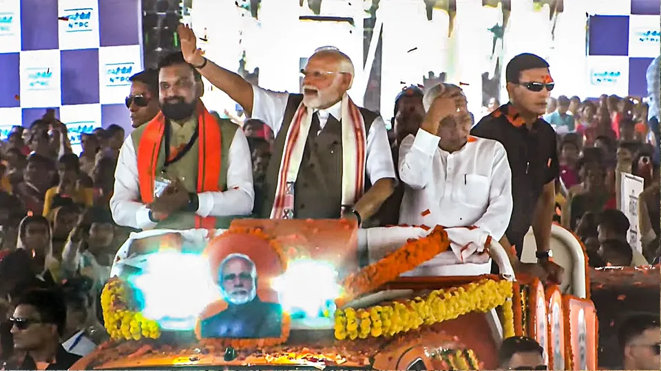 rime Minister Narendra Modi greets supporters during a public meeting, in Rohtas district, Bihar, Friday, May 30, 2025. Bihar Chief Minister Nitish Kumar and Deputy Chief Minister Samrat Choudhary are also seen. 