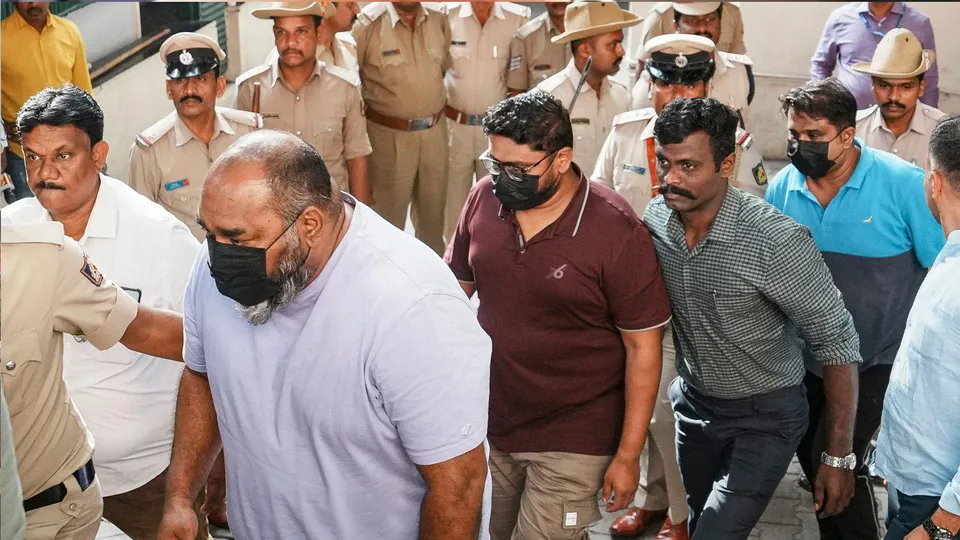DNA entertainment private limited officials, in black masks, Sunil Mathew and Kiran Kumar among others being taken to court after their arrest in connection with the stampede outside Chinnaswamy stadium, in Bengaluru, Karnataka