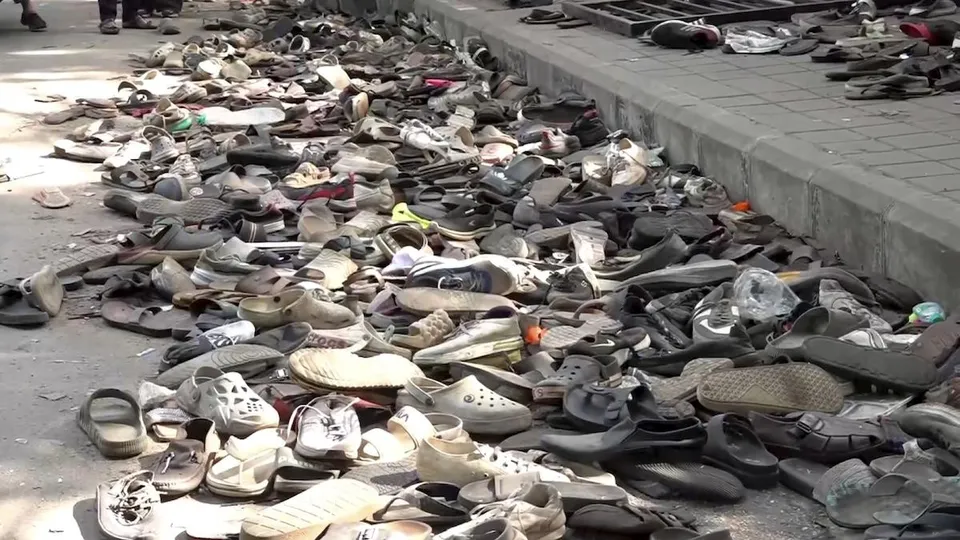 Footwear lie on the ground outside the Chinnaswamy Stadium a day after the stampede, following a large gathering of fans for the felicitation of IPL 2025 winning Royal Challengers Bengaluru team