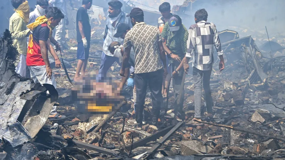 People gather at the site after an Air India plane crashed moments after taking off from the airport in Ahmedabad on Thursday, June 12, 2025. 