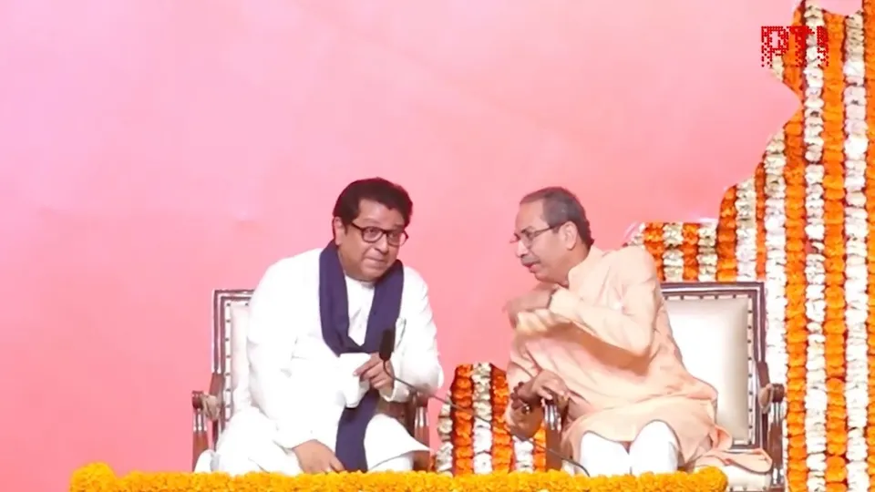 Uddhav (right) and Raj Thackeray shake hands as they hold a joint victory gathering, titled 'Awaj Marathicha' on Saturday, July 5, 2025.