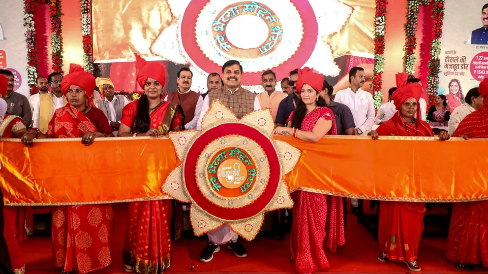 Madhya Pradesh Chief Minister Mohan Yadav being presented a huge 'rakhi' during the 'Ladli Behna Sammelan' in Ujjain, Madhya Pradesh, Saturday, July 12, 2025.