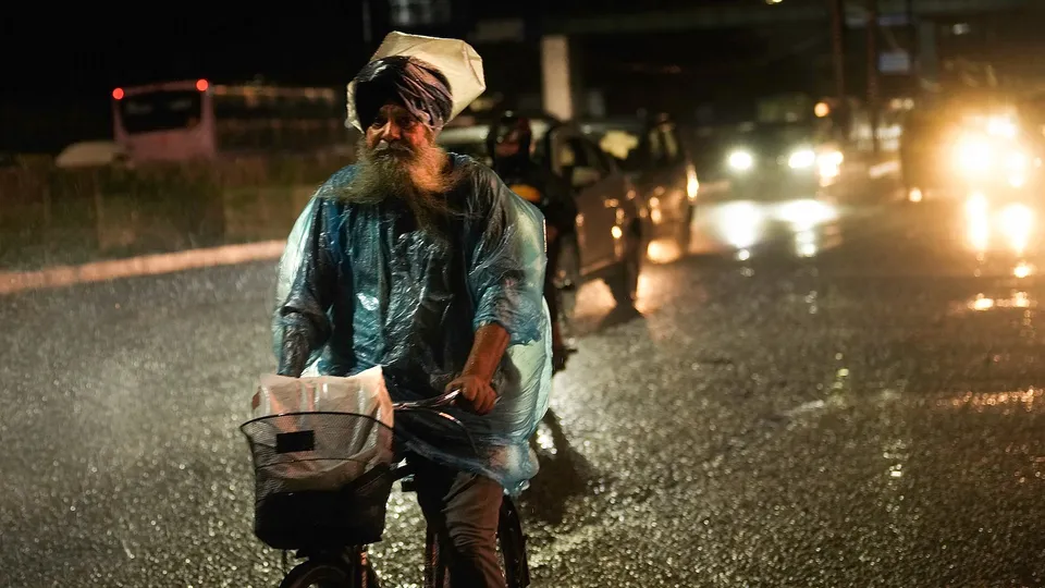 Commuters during rainfall, in New Delhi, Monday, Sept. 1, 2025.