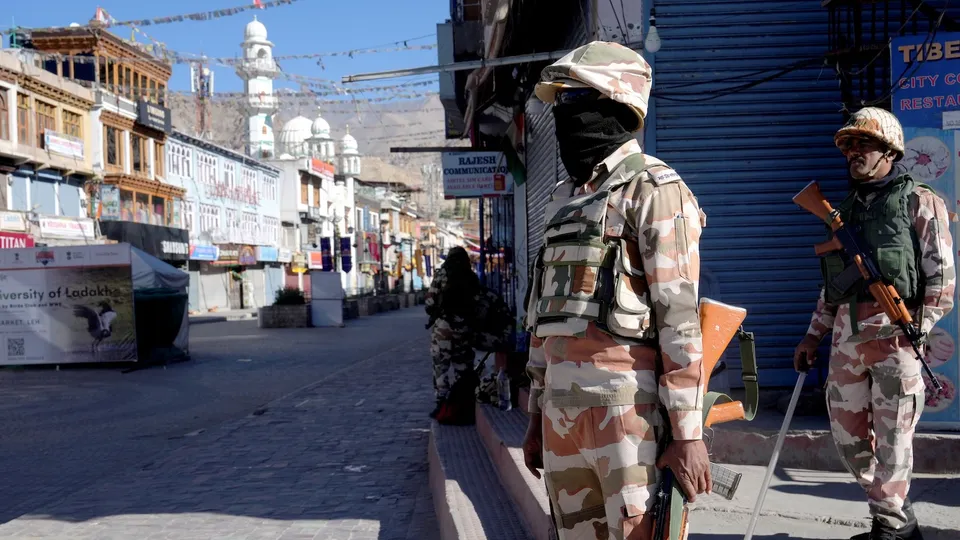 Security personnel stand guard on a street amid a curfew, in Leh, Ladakh, Saturday, Sept. 27, 2025.