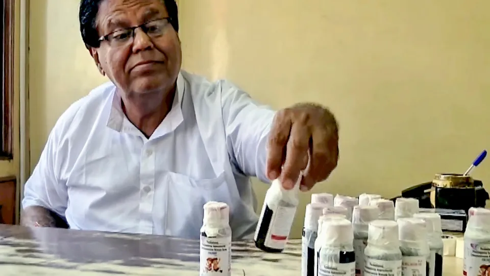 An official looks at bottles of the Coldrif cough syrup after a raid by the Drug and Pharmaceuticals Department officials at Kataria Pharmaceuticals in Jabalpur, Madhya Pradesh, Saturday, Oct. 4, 2025.