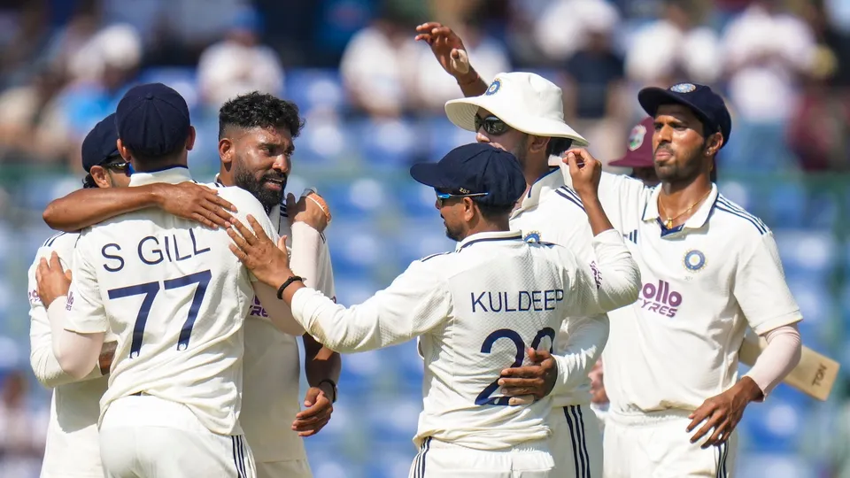 Mohammed Siraj celebrates with teammates after taking wicket of West Indies' Tagenarine Chanderpaul on day three of the second and final Test cricket match of a series between India and West Indies, in New Delhi, Sunday, Oct. 12, 2025.