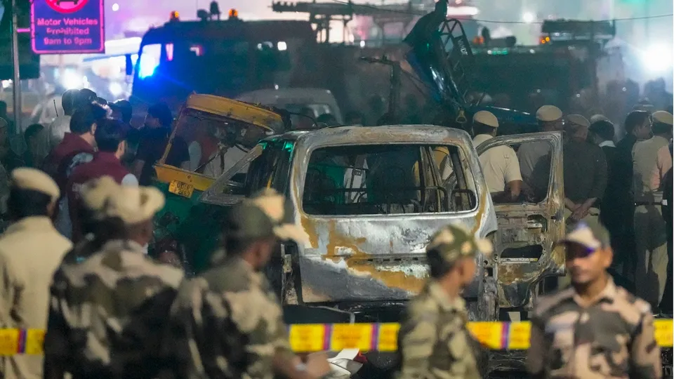 Security personnel at the spot after a blast occurred in a parked car near Red Fort, leaving multiple vehicles in flames, in New Delhi, Monday, Nov. 10, 2025.