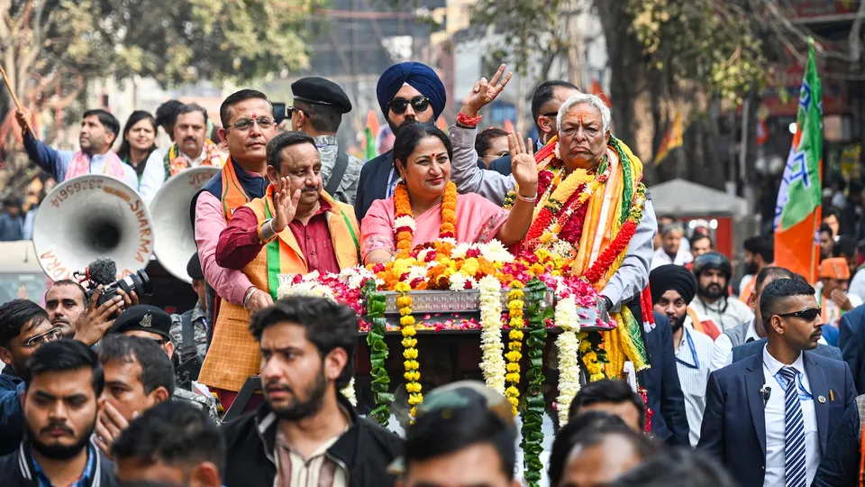 Delhi Chief Minister Rekha Gupta during a roadshow in support of BJP candidate from Chandni Chowk seat, Suman Kumar Gupta, right, ahead of the Municipal Corporation of Delhi (MCD) bypolls, in New Delhi, Friday, Nov. 28, 2025.