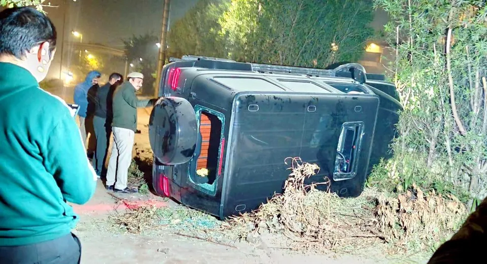 A Mercedes SUV (G63) turned over after it allegedly rammed into three near a mall in Vasant Kunj area, New Delhi, Sunday, Nov. 30, 2025. A 23-year-old man died and two others sustained injuries in the incident.