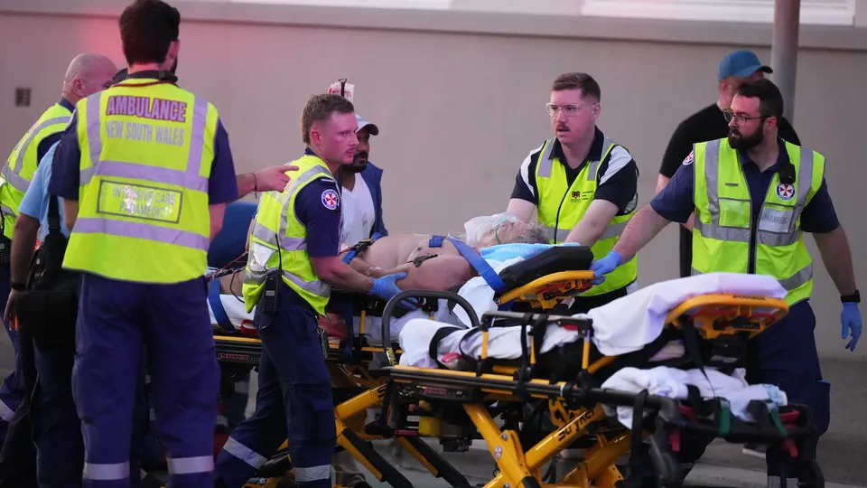 Emergency workers transport a person on a stretcher after a reported shooting at Bondi Beach in Sydney, Sunday, Dec. 14, 2025.