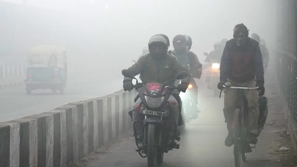 Commuters brave dense fog on a winter morning, in New Delhi, Saturday, Dec. 20, 2025.