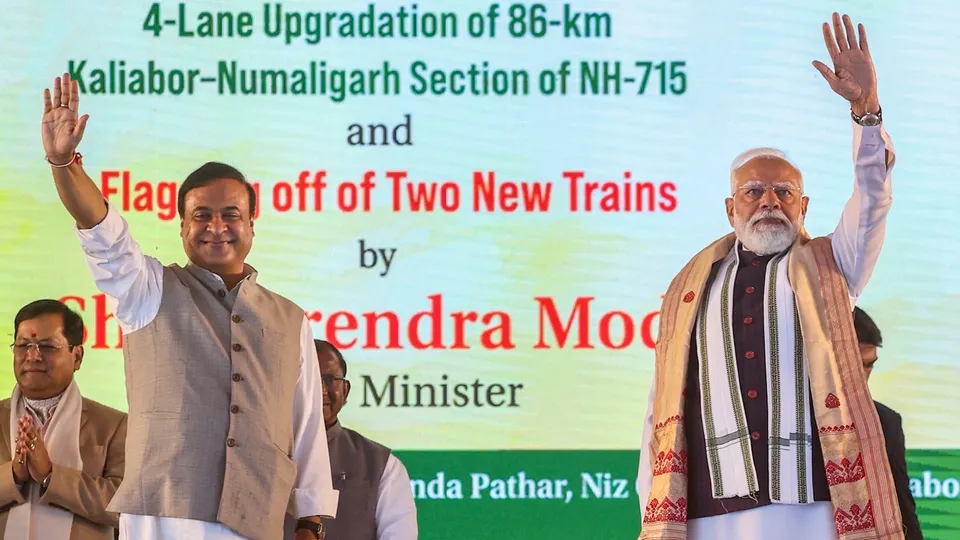 Narendra Modi and Assam Chief Minister Himanta Biswa Sarma wave to the gathering during the foundation stone laying ceremony for the Kaziranga Elevated Corridor, in Nagaon district, Assam, on Sunday, Jan 18, 2026.