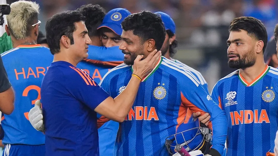 Sanju Samson, front centre, being congratulated by head coach Gautam Gambhir, front left, after winning the ICC Men's T20 World Cup 2026 final cricket match against New Zealand at Narendra Modi Stadium in Ahmedabad on Sunday, March 8, 2026.