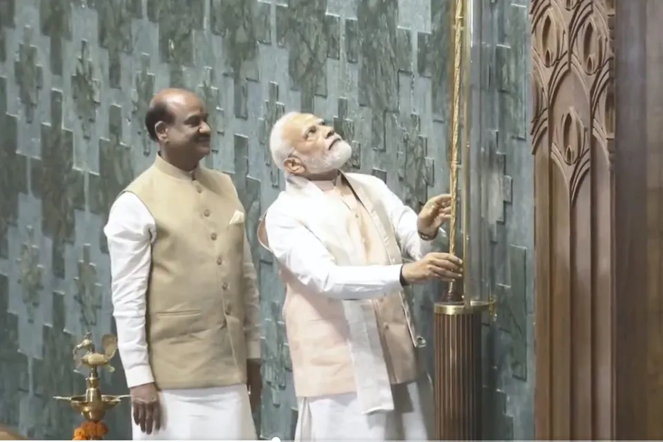 Prime Minister Narendra Modi installs the 'Sengol' in an enclosure on the right side of the Speaker's chair in the Lok Sabha chamber at the inauguration of the new Parliament building
