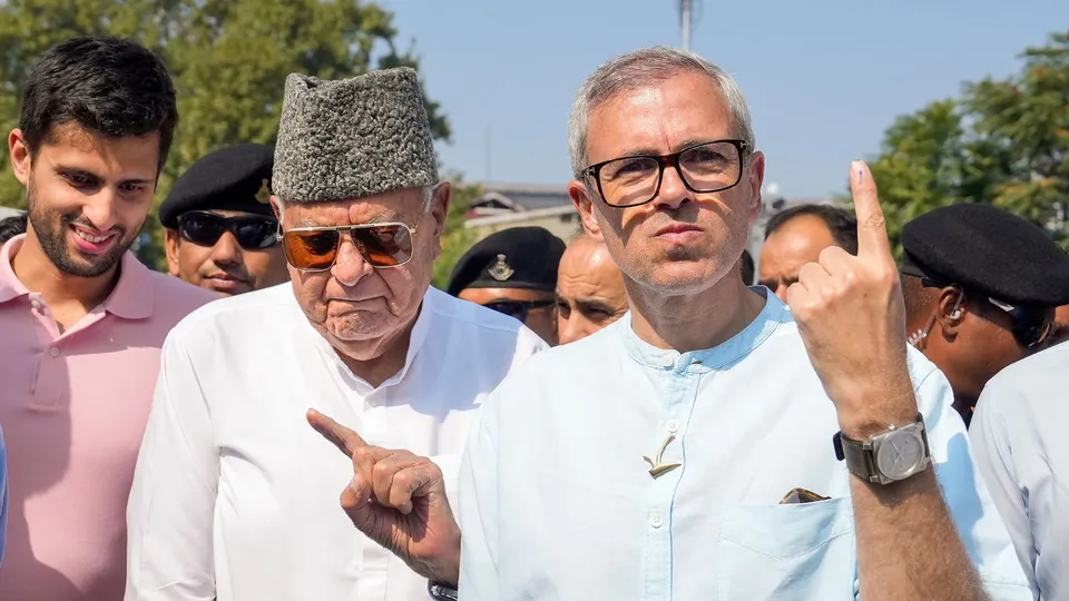 National Conference (JKNC) President Farooq Abdullah and Vice President Omar Abdullah show their fingers marked with indelible ink after casting a vote, in Srinagar, Wednesday, Sept. 25, 2024.