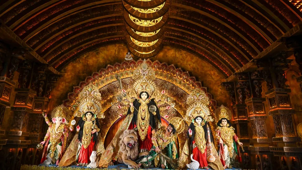 Visitors at a Durga Puja community pandal themed on 'Three dimemsion of the Universe' during 'Maha Panchami' of Durga Puja festival, in Kolkata, Tuesday, Oct. 8, 2024.