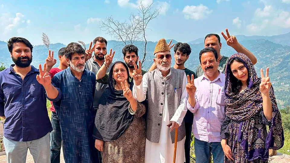 BJP candidate from Surankote constituency Syed Mushtaq Ahmad Bukhari poses for photos with others after casting vote during the second phase of Jammu and Kashmir Assembly elections.