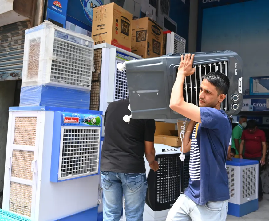 People purchase water coolers at a shop on a hot summer day, in Gurugram