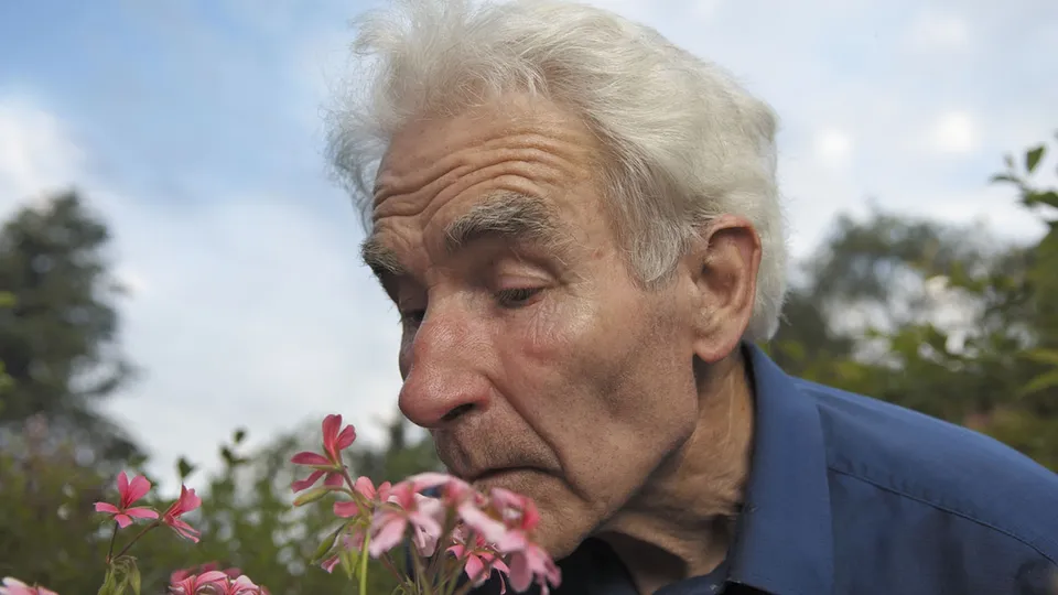Man smelling flowers