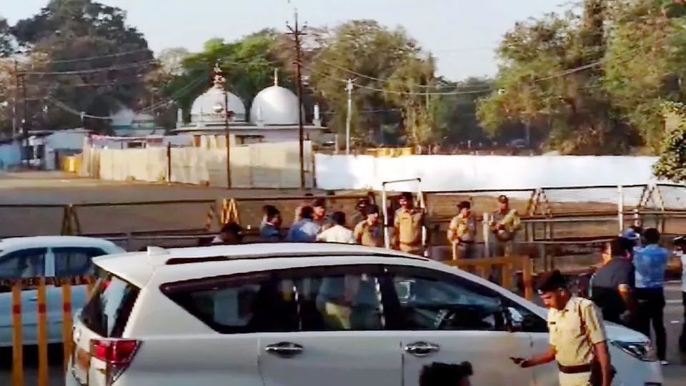 Security personnel stand guard outside Bhojshala/Kamal Maula Mosque complex after a team of the Archaeological Survey of India (ASI) reached the complex for a survey, in Dhar