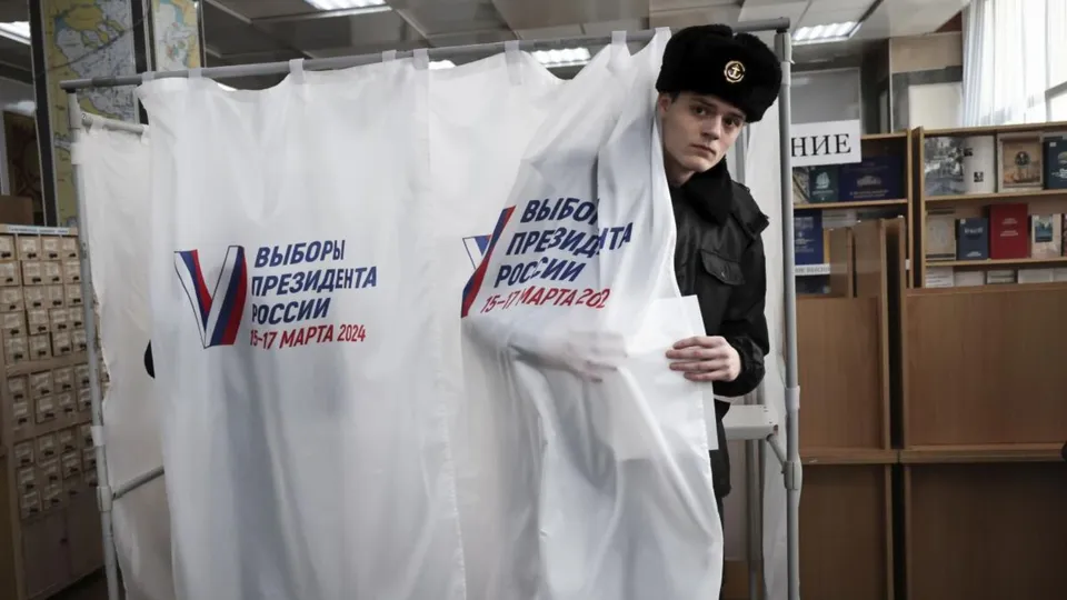 A student of the Maritime State University, Gennady Nevelskoy, leaves a voting booth at a polling station in Vladivostok, Russia, on Friday