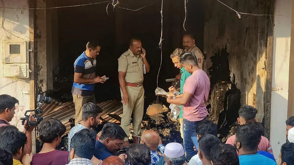 Police personnel and locals at the site after a fire broke out at a tailoring shop, in Chhatrapati Sambhajinagar, Wednesday, April 3, 2024