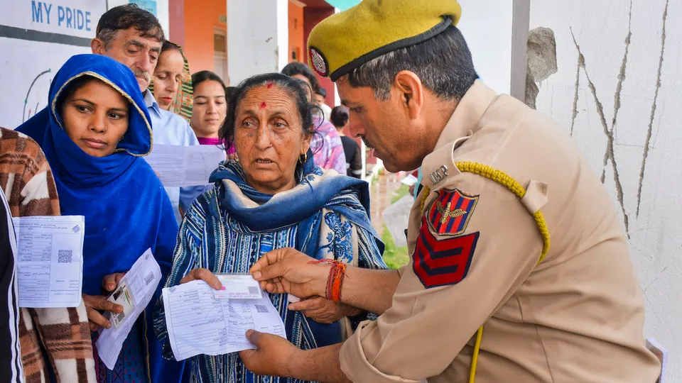 Voters wait in queues at a polling station to cast their votes for the first phase of Lok Sabha elections, in Udhampur district, Friday, April 19, 2024.