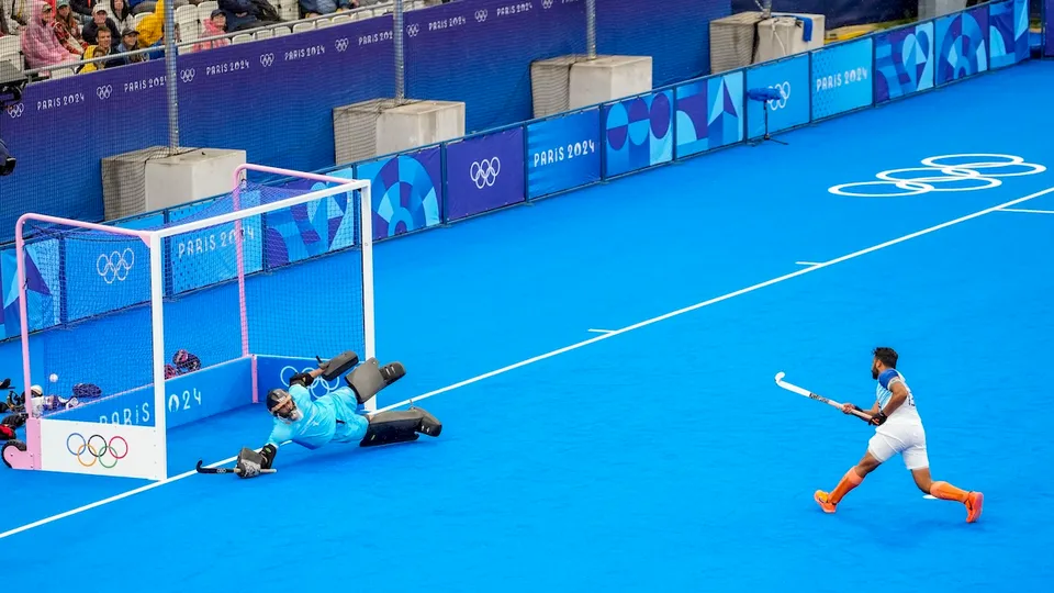 India's Harmanpreet Singh scores a goal from a penalty stroke against New Zealand during the Pool B hockey match between India and New Zealand, at the Summer Olympics 2024, in Paris, Saturday, July 27, 2024.