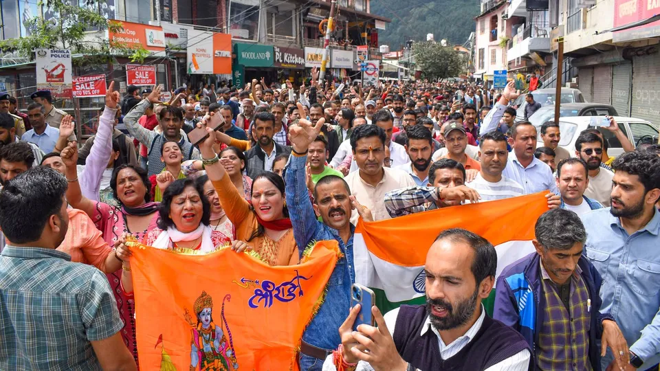 People raise slogans during a protest against the alleged illegal construction of a mosque, in Shimla, Thursday, Sept. 5, 2024.