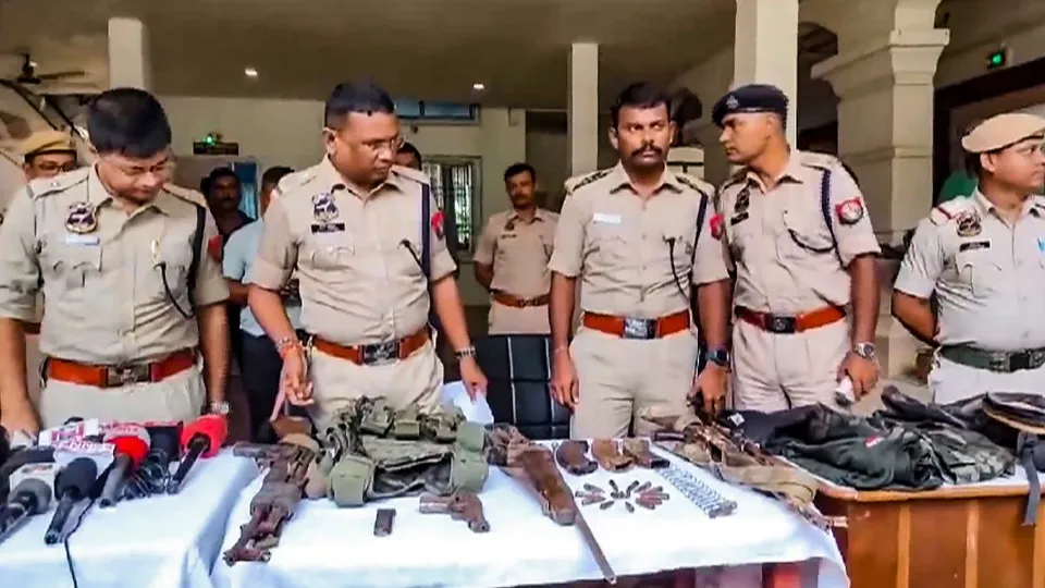 Police personnel display the arms and ammunition recovered after an encounter with alleged Hmar terrorists, in Cachar district of Assam, Wednesday, July 17, 2024