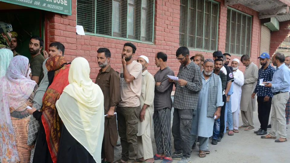 People wait in queues to cast their votes at a polling station during the second phase of Assembly elections, in Srinagar, Wednesday, Sept. 25, 2024.