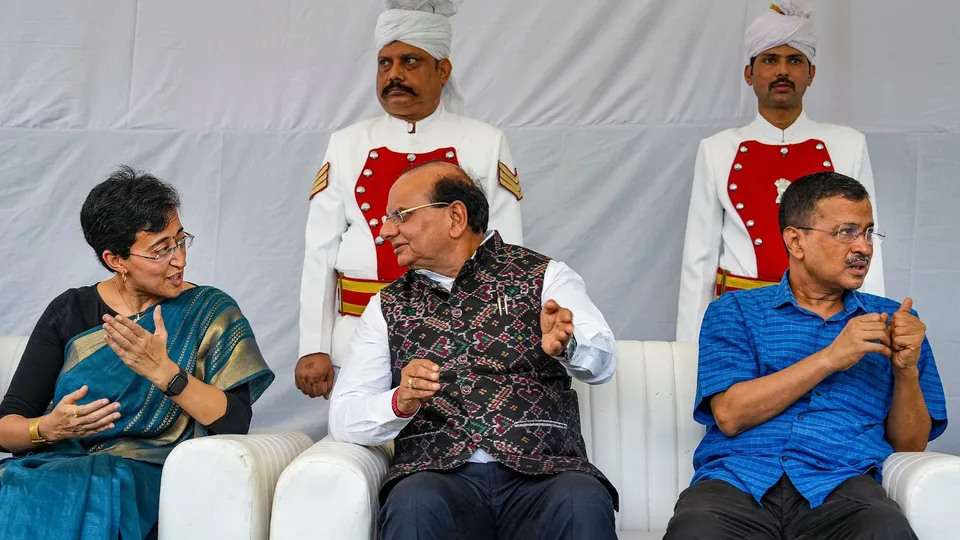 Delhi Lt. Governor V.K. Saxena with former chief minister Arvind Kejriwal and CM-designate Atishi during her swearing-in ceremony, at Raj Niwas, in New Delhi, Saturday, Sept. 21, 2024.