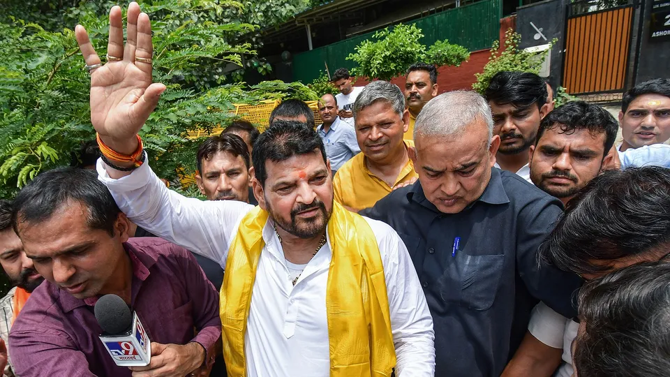 BJP MP Brij Bhushan Singh shows support for his candidates as they leave for federation polls, at Jantar Mantar in New Delhi