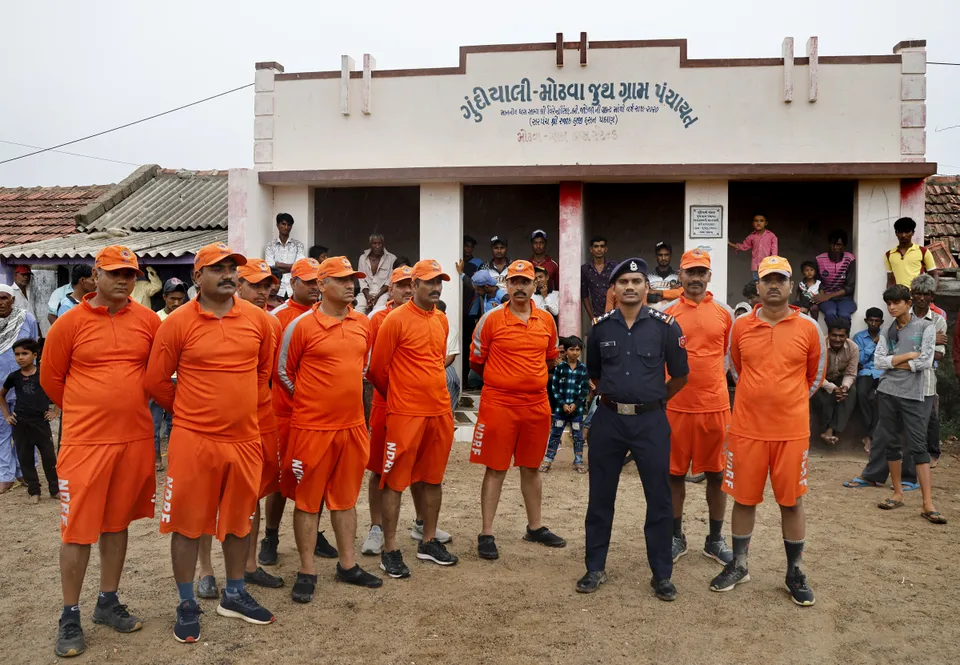 National disaster response force (NDRF) personnel brief citizens ahead of cyclone Biparjoy’s landfall, at Mandvi, in Kutch